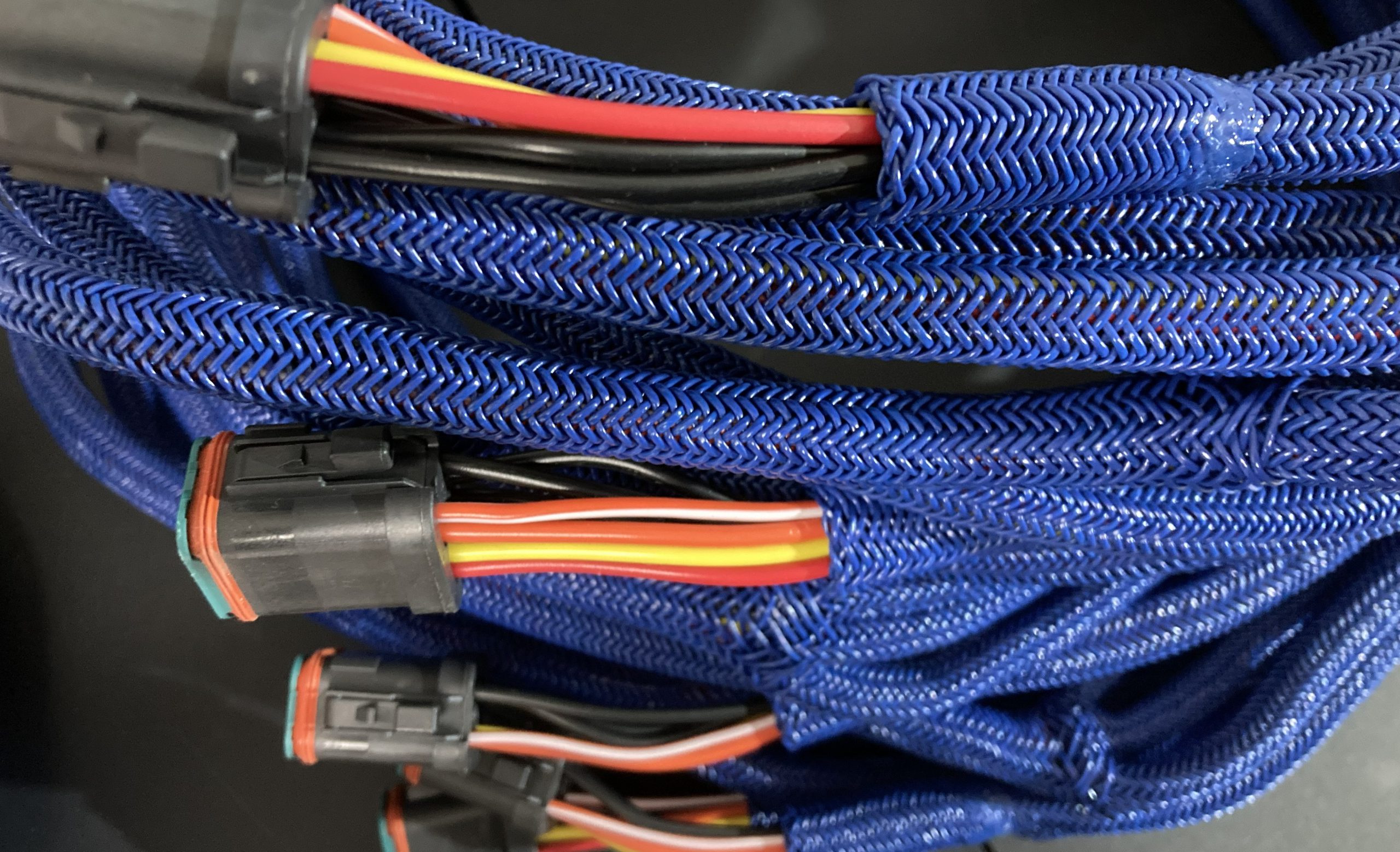 Braiding machine winding finished braid onto a reel